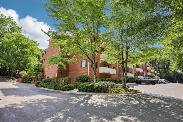 302 Ridley Howard Ct Unit 302, Decatur, GA 30030 - view of property exterior with uncovered parking and brick siding