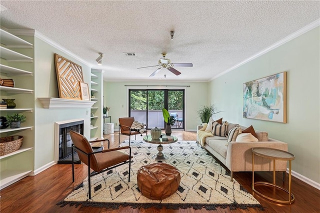 302 Ridley Howard Ct Unit 302, Decatur, GA 30030 - living area featuring wood finished floors, a textured ceiling, ceiling fan, a fireplace, and crown molding