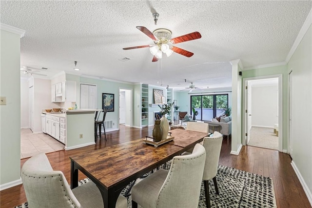 302 Ridley Howard Ct Unit 302, Decatur, GA 30030 - dining space featuring a ceiling fan, ornamental molding, a textured ceiling, and wood finished floors