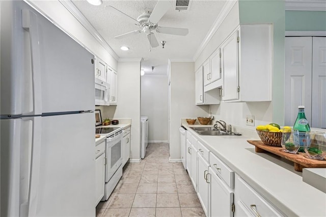 302 Ridley Howard Ct Unit 302, Decatur, GA 30030 - kitchen featuring white appliances, crown molding, white cabinetry, light countertops, and washing machine and dryer