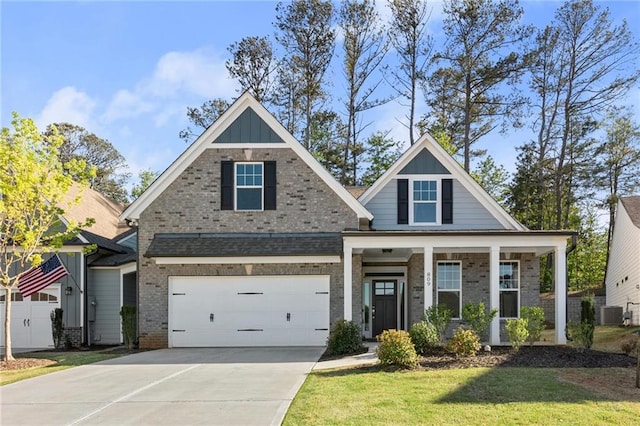craftsman inspired home with concrete driveway, board and batten siding, an attached garage, covered porch, and a front yard