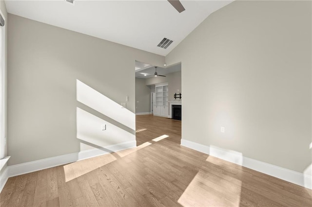 empty room featuring a ceiling fan, wood finished floors, and visible vents