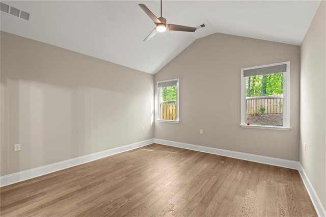 spare room featuring plenty of natural light, wood finished floors, visible vents, and ceiling fan