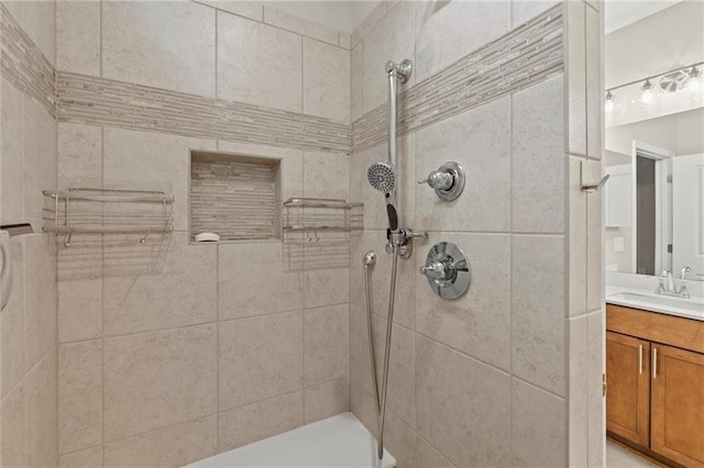 bathroom featuring vanity and a tile shower
