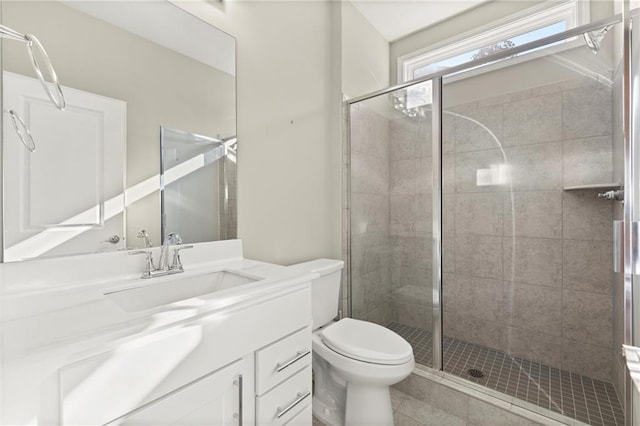 full bath with tile patterned flooring, toilet, vanity, and a stall shower