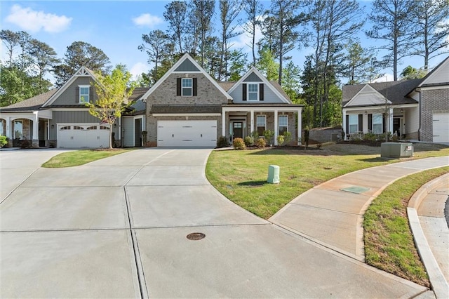 craftsman house featuring a garage, brick siding, a front lawn, and concrete driveway