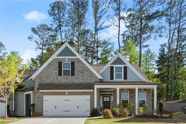 craftsman-style house with driveway, a porch, brick siding, a shingled roof, and board and batten siding