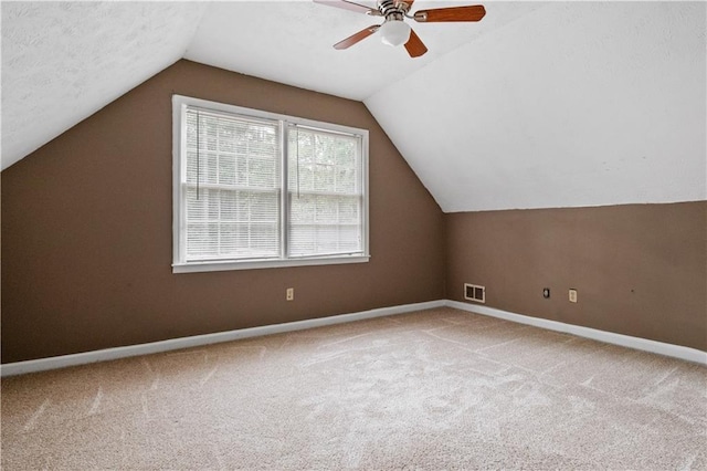 6945 Butner Rd, Atlanta, GA 30349 - bonus room with carpet floors, a ceiling fan, baseboards, vaulted ceiling, and visible vents