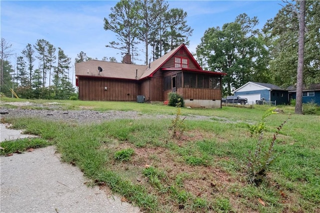 6945 Butner Rd, Atlanta, GA 30349 - exterior space featuring central air condition unit, a chimney, a sunroom, and crawl space