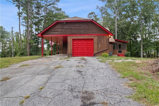 garage with a carport and central AC unit