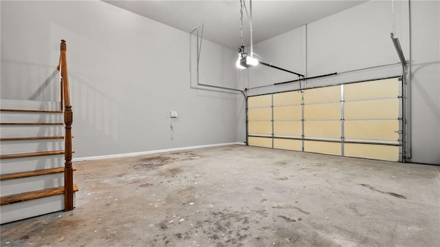 garage with baseboards and a garage door opener