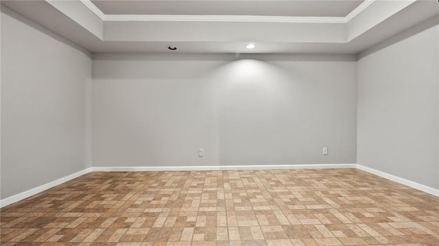 spare room featuring crown molding and baseboards