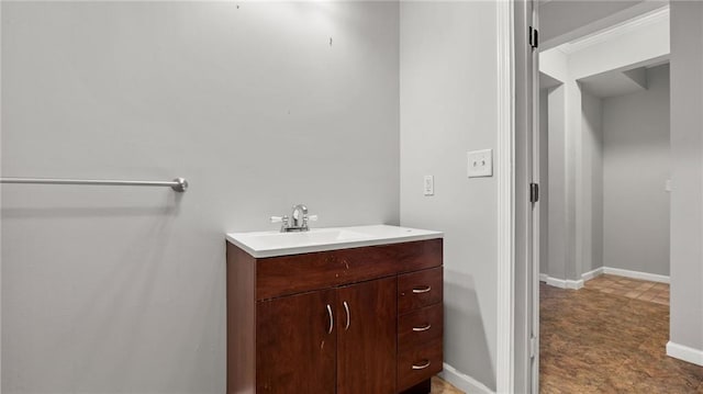 bathroom featuring baseboards and vanity