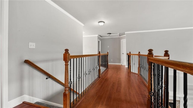 corridor with crown molding, wood finished floors, an upstairs landing, and baseboards