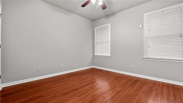 unfurnished room featuring ceiling fan, baseboards, and wood finished floors