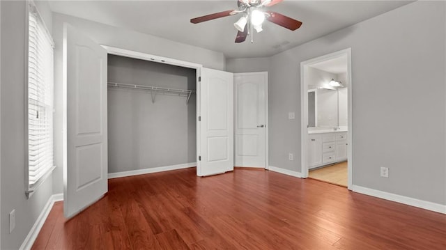 unfurnished bedroom featuring a closet, ceiling fan, baseboards, and wood finished floors