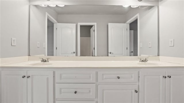 bathroom with a sink and double vanity