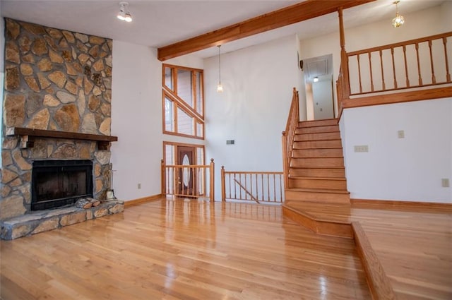 living room featuring hardwood / wood-style floors and a stone fireplace