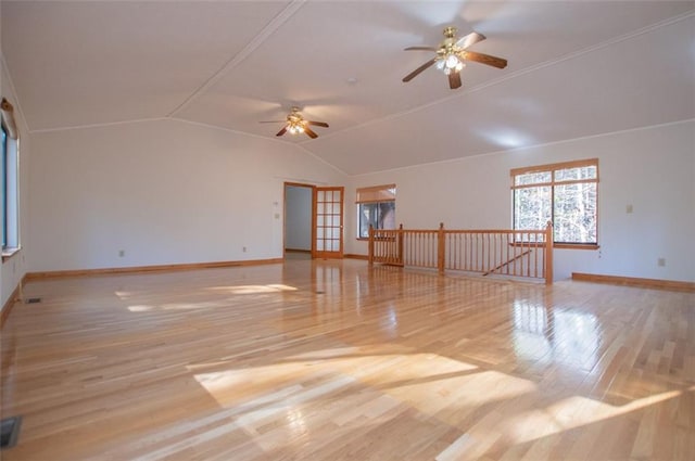 spare room featuring lofted ceiling, ceiling fan, and light wood-type flooring