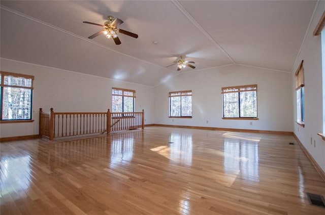 unfurnished room with ceiling fan, light hardwood / wood-style floors, and lofted ceiling