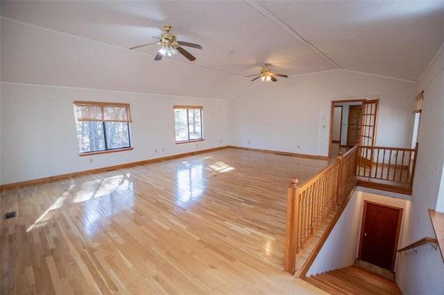 spare room with light hardwood / wood-style flooring, ceiling fan, and lofted ceiling