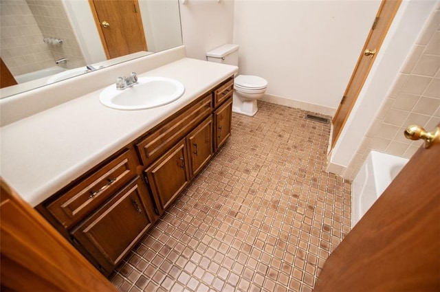 full bathroom featuring vanity, toilet, and tiled shower / bath