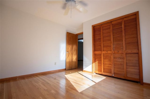 unfurnished bedroom with a closet, light hardwood / wood-style floors, and ceiling fan