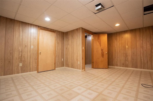 basement featuring wood walls