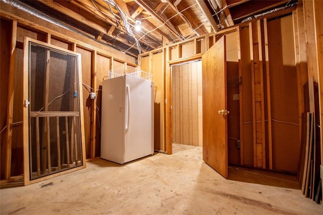 basement with white refrigerator