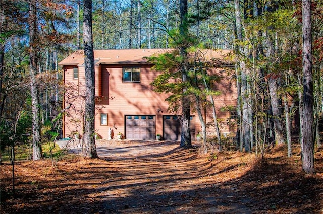 back of property featuring a garage