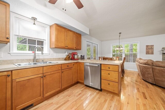 kitchen with kitchen peninsula, dishwasher, ceiling fan, light hardwood / wood-style flooring, and sink