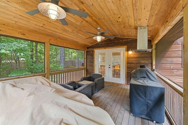 interior space with ceiling fan, lofted ceiling, french doors, and wood ceiling