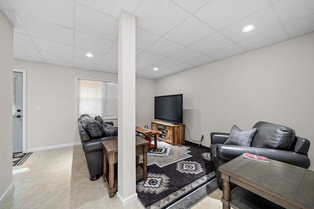 tiled living room with a drop ceiling