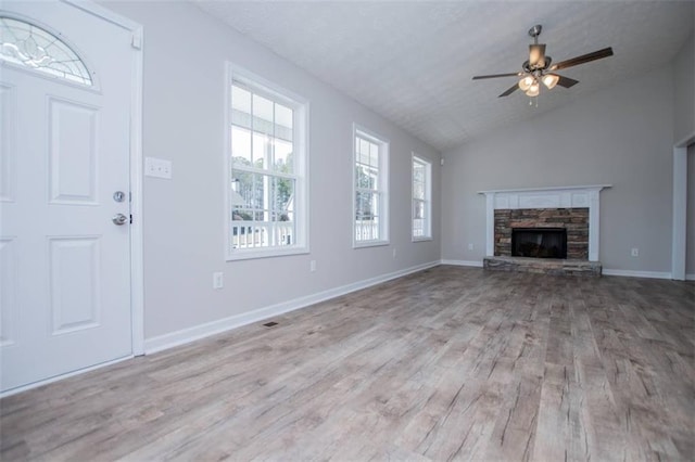 unfurnished living room featuring baseboards, wood finished floors, lofted ceiling, and ceiling fan