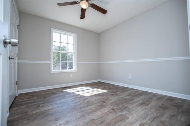 unfurnished room featuring visible vents, baseboards, wood finished floors, and a ceiling fan