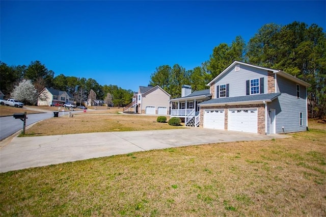 view of yard with concrete driveway and an attached garage