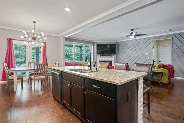 kitchen with open floor plan, a sink, a center island with sink, and dishwasher