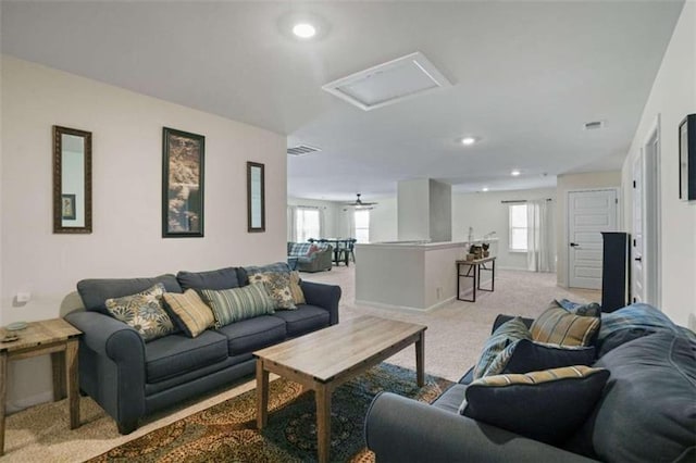 living room featuring attic access, recessed lighting, light carpet, and visible vents