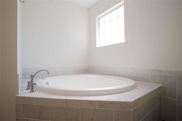 bathroom with tiled tub