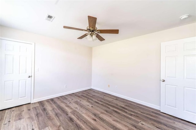 empty room with ceiling fan and hardwood / wood-style flooring