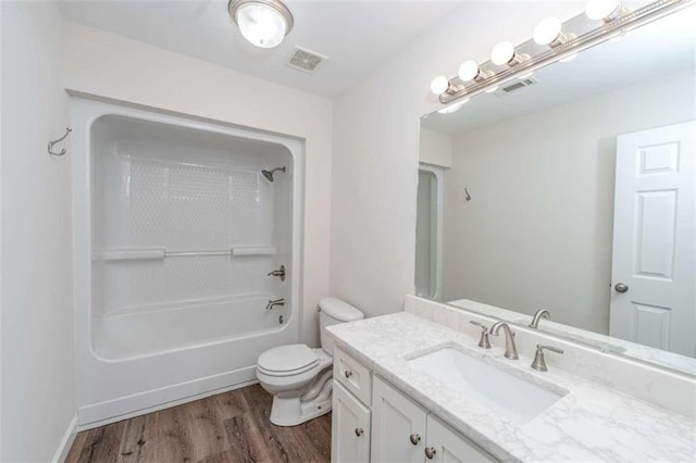 full bathroom with wood-type flooring,  shower combination, vanity, and toilet