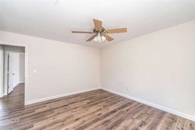 spare room featuring ceiling fan and dark hardwood / wood-style flooring