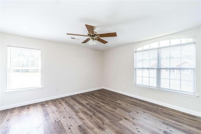 spare room with ceiling fan and hardwood / wood-style flooring