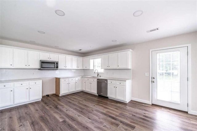 kitchen featuring stainless steel appliances, dark hardwood / wood-style floors, white cabinets, and sink