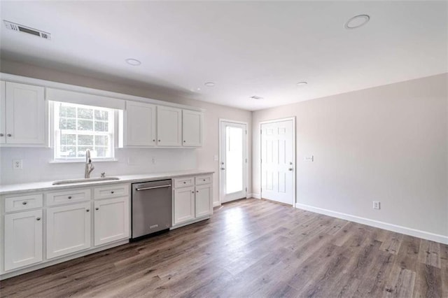 kitchen featuring dishwasher, light hardwood / wood-style floors, sink, and white cabinetry