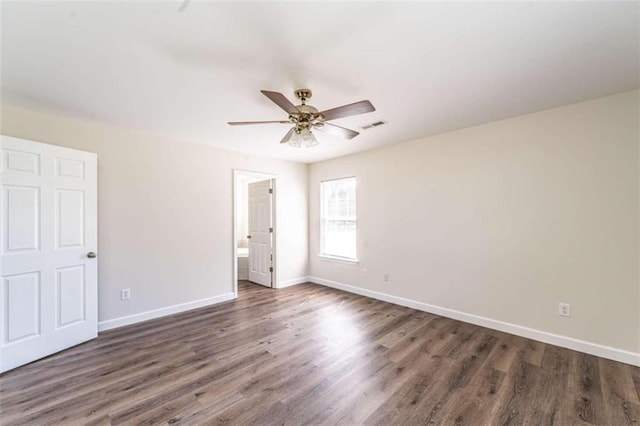 empty room featuring ceiling fan and dark wood-type flooring