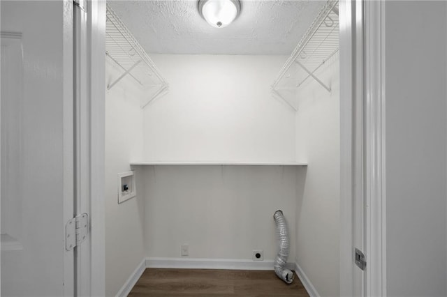 clothes washing area featuring washer hookup, a textured ceiling, dark wood-style floors, baseboards, and laundry area