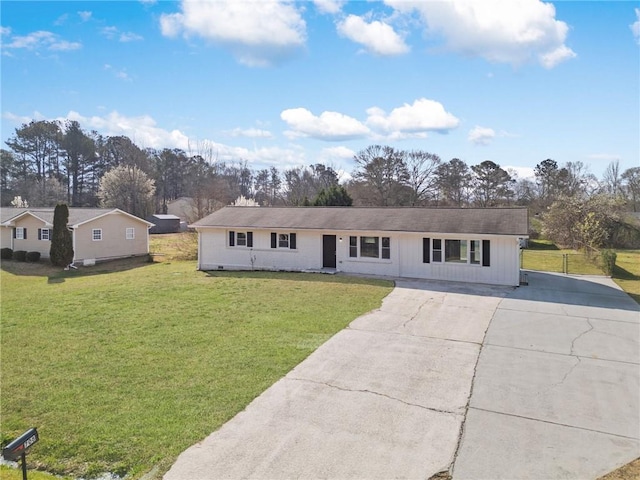 single story home with a front yard, board and batten siding, and driveway