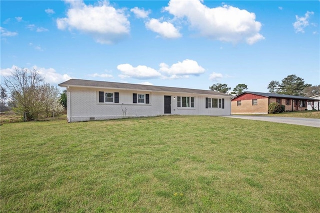 ranch-style home featuring crawl space, brick siding, concrete driveway, and a front lawn