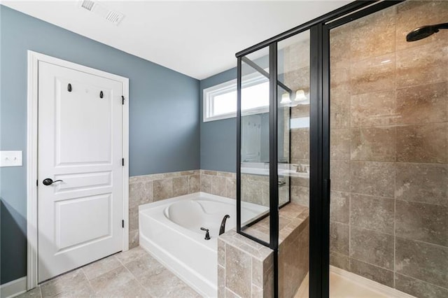 bathroom with tile patterned floors and plus walk in shower